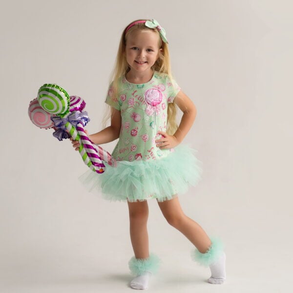 Daga - More Sugar 2025 Summer Collection - Gorgeous dress loose fitting jersey dress with all over Daga More Sugar Lollipop print. Soft stretchy jersey dress with cap sleeves and double ruffle hem in soft green tulle with a large applique Lollipop with diamante on the front. single button at the back of the neck. This is an ICONIC Daga dress - a must have for every season. Loose fitting and easy to fit and wear.