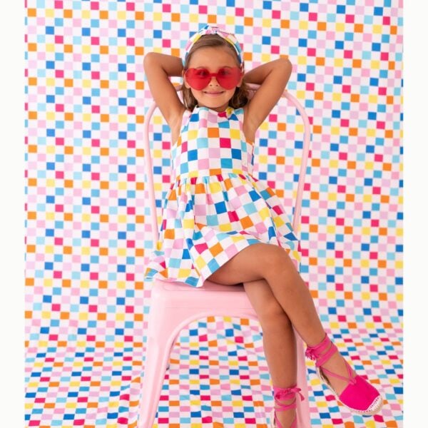 In a colourful checkerboard pattern, this fun dress for girls is by Agatha Ruiz de la Prada. Woven in smooth cotton poplin, the sleeveless design has a lightweight lining and pink heart buttons for fastening on the back. A branded patch on the front adds a subtle designer touch.