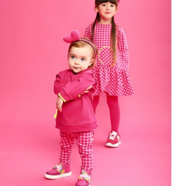 In vibrant fuchsia pink, this fun and playful legging set for girls is by Agatha Ruiz de la Prada. Made in soft cotton-blend jersey, the sweatshirt features a yellow heart motif and neon yellow trims, with popper fastenings on the smaller sizes. The coordinating pink gingham leggings have a comfortable elasticated waist.