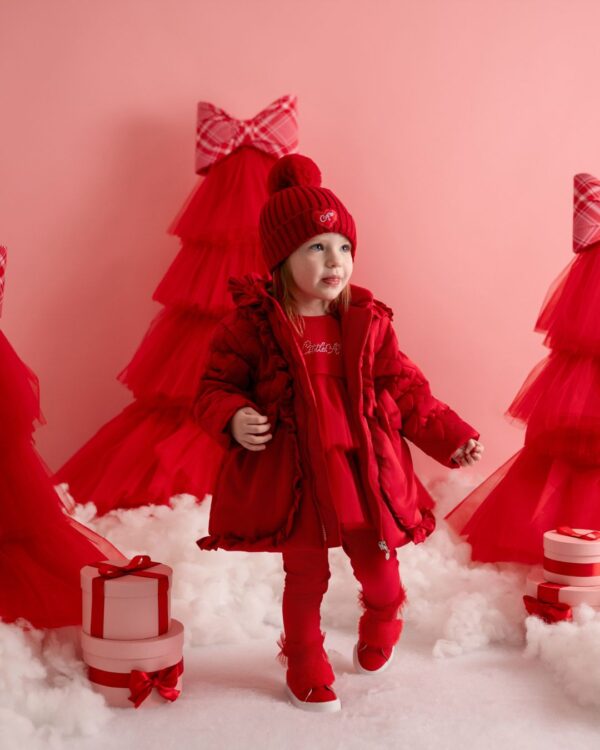The Kaia puff jacket features heart embroidery all over, frill hem and hood details, finished with two applique bows at the front and one on the back.