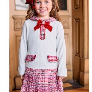 Lovely ivory and red dress for younger girls by Patachou, combining a soft ribbed viscose-blend knit with pretty tweed. Classically styled, it has a lovely rounded collar and faux front pocket detail. The skirt is pleated for a little extra volume and the dress is lined for comfort, with a neat zip fastening on the back. A red velvet bow and sparkling crystal buttons on the front add a sweet finishing touch.