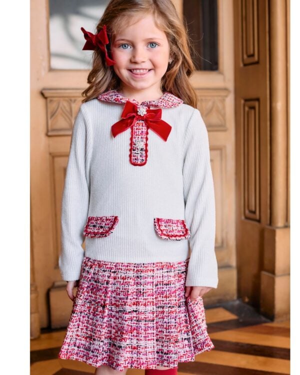 Lovely ivory and red dress for younger girls by Patachou, combining a soft ribbed viscose-blend knit with pretty tweed. Classically styled, it has a lovely rounded collar and faux front pocket detail. The skirt is pleated for a little extra volume and the dress is lined for comfort, with a neat zip fastening on the back. A red velvet bow and sparkling crystal buttons on the front add a sweet finishing touch.