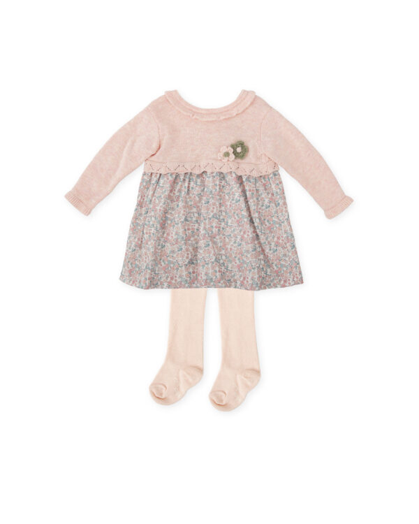 This charming dress set for little girls by Tutto Piccolo, features a dress with a pretty pink and green floral skirt. The dress has a cosy, knitted bodice with a sweet ruffled collar. For easy dressing, it fastens with buttons on the back. A pair of pink knitted tights completes the look.