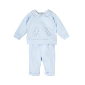 A pale blue trouser set for little boys by Babidu, made in soft cotton jersey with a charming quilted-effect. The long-sleeved top has a traditional gingham check collar and sweet pouch pocket on the front. It fastens on the back with poppers and is paired with comfortable elasticated trousers with fixed turned-up cuffs.